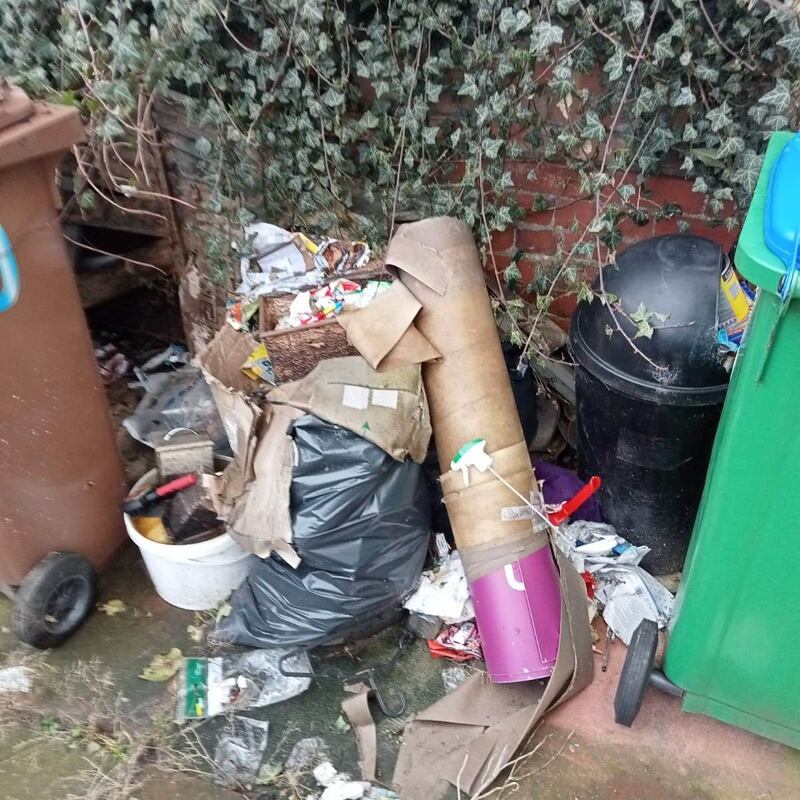 House rubbish piled up in the garden